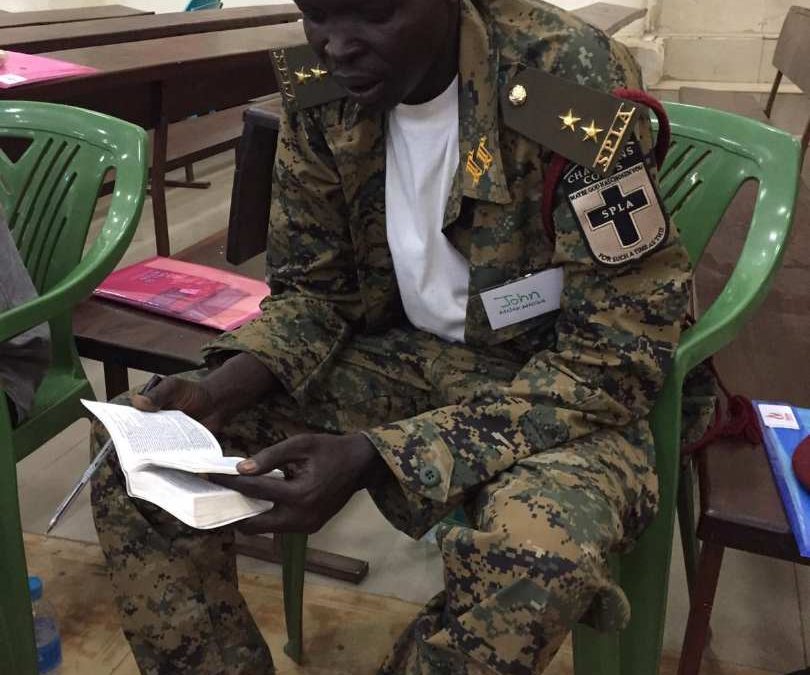 Soldier reading bible in South Sudan church